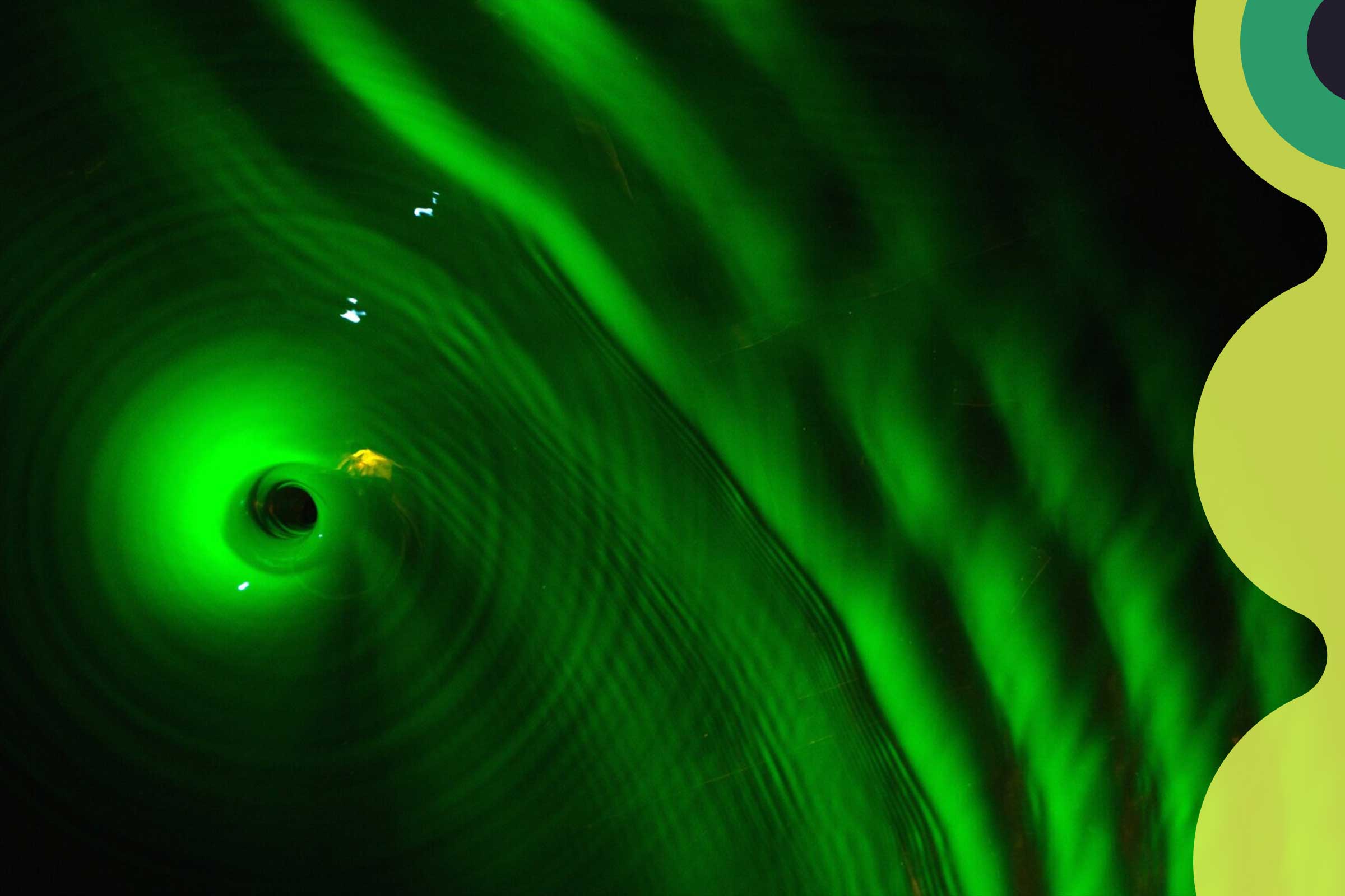 A black hole represented in a sea of cosmic brightness, rung with light and gases, next to a Texas Science Festival graphic.