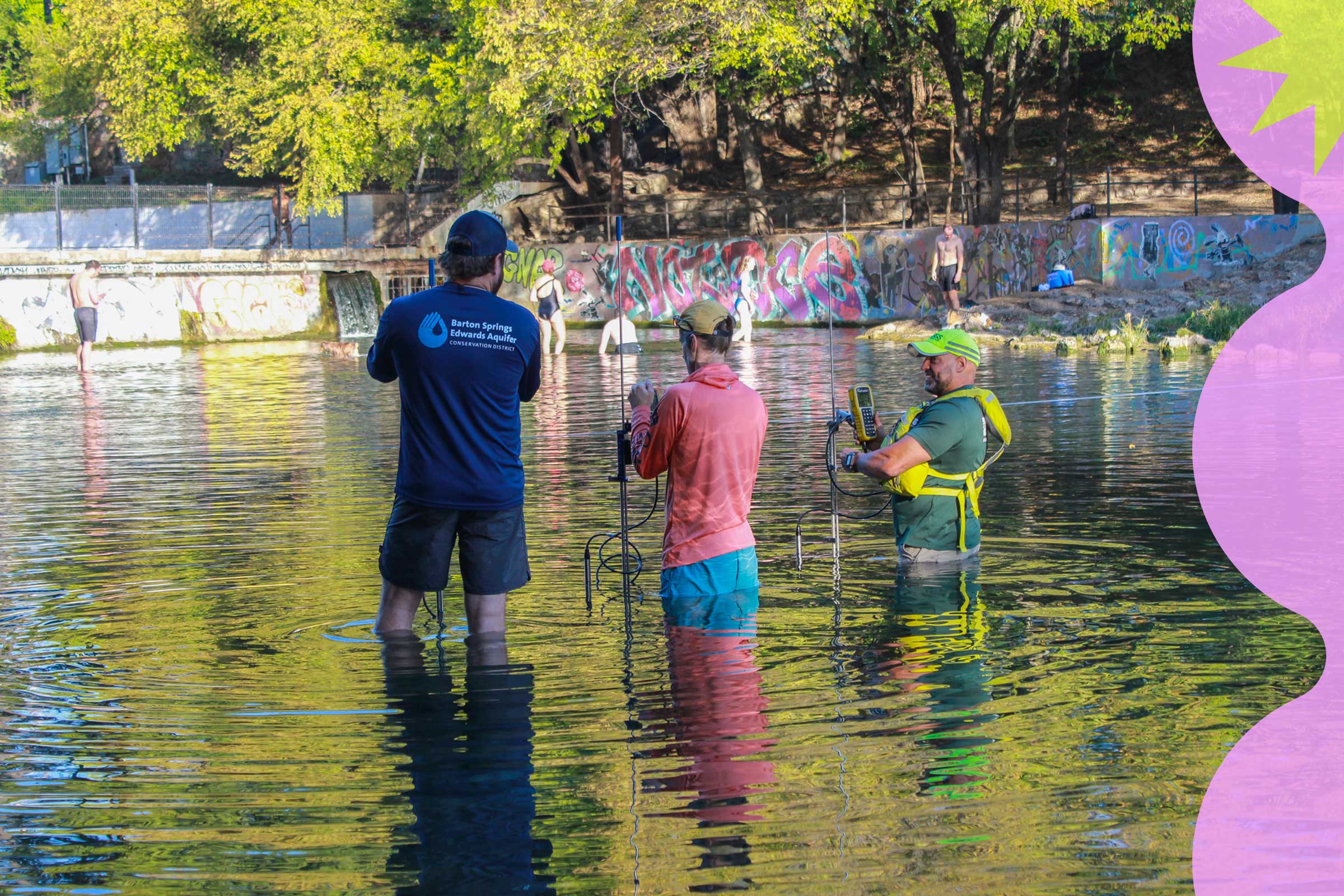 Three members of the Barton Springs Edwardsa Aquifer Conservation District use equipment to monitor the water as members of the public play in the water in the distance.